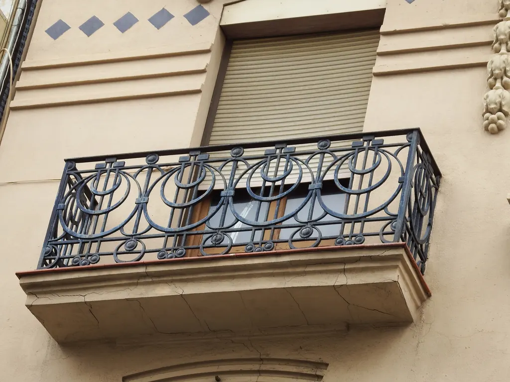 Wrought iron balcony on a facade in the Ruzafa district of Valencia